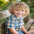 Joyful Child Portrait in Nature: Smiling Boy with Curly Hair on a Bench