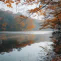 Tranquil Autumn Reflections: Serene Lake Surrounded by Colorful Fall Foliage