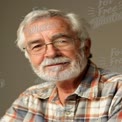 Senior Man with Glasses and White Beard Smiling in Casual Attire