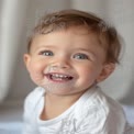 Joyful Baby Smiling with Bright Blue Eyes - Happy Childhood Moments