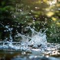 Dynamic Water Splash with Sunlight Bokeh - Nature and Refreshment Concept