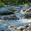 Tranquil River Flowing Through Rocky Landscape - Nature Serenity and Outdoor Adventure