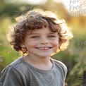 Joyful Child in Nature: Smiling Boy with Curly Hair in Sunlit Field