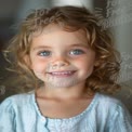 Joyful Child Portrait with Bright Blue Eyes and Curly Hair