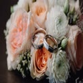 Elegant Wedding Rings on Floral Bouquet: Romantic Engagement and Marriage Concept