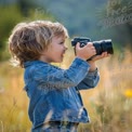 Child Photography Enthusiast in Nature: Capturing Moments in a Scenic Field