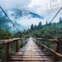 Serene Suspension Bridge in Misty Mountain Landscape