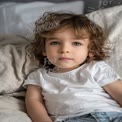 Adorable Child Portrait with Curly Hair in Cozy Bedroom Setting