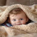 Adorable Baby Peeking from Cozy Blanket - Warmth and Comfort