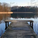 Tranquil Lakeside Dock at Sunrise: Serene Nature Reflection