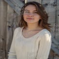 Natural Beauty Portrait of Young Woman in Casual Sweater Against Rustic Background