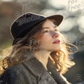 Elegant Young Woman in Stylish Hat with Natural Light Portrait