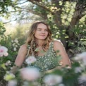 Serene Woman in Nature Surrounded by Flowers - Relaxation and Wellness Concept