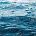 Close-Up of Water Surface with Bubbles and Ripples - Tranquil Blue Ocean Texture