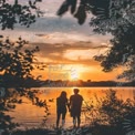 Romantic Sunset Silhouette: Couple Holding Hands by the Water