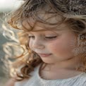 Joyful Childhood Moments: Close-Up of a Young Girl with Curly Hair in Natural Light