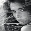 Captivating Black and White Portrait of a Young Woman with Freckles and Flowing Hair