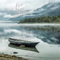 Tranquil Lake Landscape with Misty Mountains and Abandoned Boat