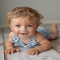 Adorable Baby Smiling on Wooden Floor - Cute Infant Portrait