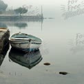 Tranquil Misty Morning: Serene Boat Reflection on Calm Water