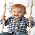 Adorable Toddler on Swing: Joyful Childhood Moments