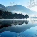 Tranquil Mountain Lake at Dawn: Serene Reflections and Misty Landscape