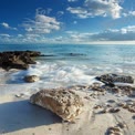 Tranquil Beach Scene with Gentle Waves and Rocky Shoreline