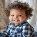 Adorable Smiling Toddler with Curly Hair in Checkered Shirt - Joyful Childhood Moments