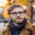 Stylish Young Man with Glasses in Autumn Park Setting