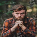 Thoughtful Man in Nature: Rustic Outdoor Portrait with Beard and Flannel Shirt