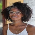 Confident Young Woman with Curly Hair and Glasses Smiling Outdoors