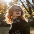 Autumn Portrait of a Young Woman with Glasses in Nature