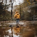 Child Exploring Nature in Autumn Rain: Adventure, Reflection, and Outdoor Play