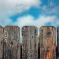 Rustic Wooden Fence Against a Bright Blue Sky