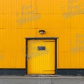 Vibrant Yellow Industrial Door Against Bold Wall Background