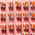 Colorful Sushi Rolls Arrangement on Pink Background - Fresh Japanese Cuisine