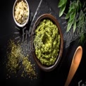 Fresh Homemade Pesto Sauce with Herbs and Ingredients on Slate Background