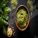 Fresh Basil Pesto with Pine Nuts and Ingredients on Dark Background