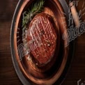 Succulent Gourmet Steak on Rustic Wooden Platter with Fresh Herbs and Sea Salt