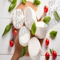 Fresh Mozzarella Cheese with Cherry Tomatoes and Basil on Wooden Cutting Board