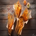 Delicious Crispy Snack Sticks in Rustic Paper Cups on Wooden Table