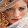 Captivating Close-Up of a Freckled Bride with Curly Hair and Mesmerizing Green Eyes