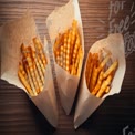 Delicious Golden Crinkle Cut French Fries in Paper Cones