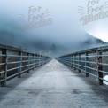 Serene Foggy Bridge in Nature: Tranquil Pathway Through Misty Landscape