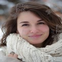 Cozy Winter Portrait of a Smiling Young Woman in a Knit Scarf