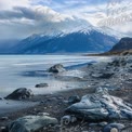 Stunning Mountain Landscape with Snow-Capped Peaks and Serene Lake Shoreline