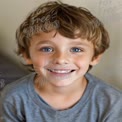 Joyful Child Portrait with Bright Smile and Sparkling Blue Eyes