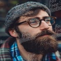 Stylish Bearded Man with Glasses and Knit Hat in Urban Setting