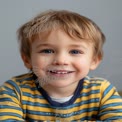 Joyful Child Portrait with Bright Blue Eyes and Playful Expression