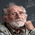 Thoughtful Elderly Man Portrait with Glasses and Beard